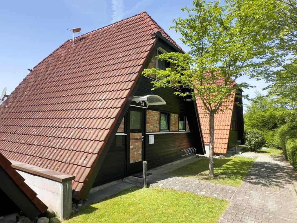 a house with a red roof at Ferienhaus Exquisit in Immenstaad am Bodensee