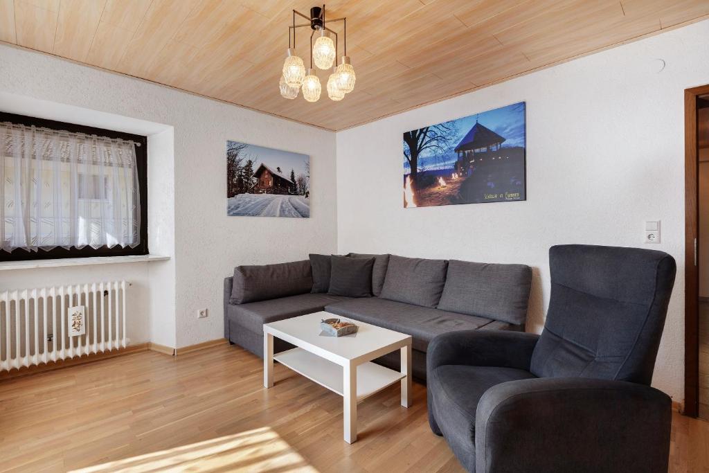 a living room with a couch and a table at Apartment Alte Poststation in Wehr