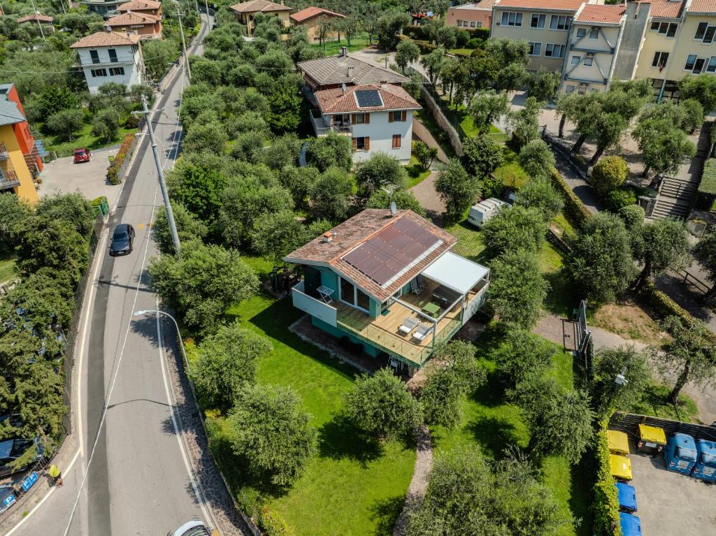 a house with a roof on a yard with a road at Casa Titi in Malcesine
