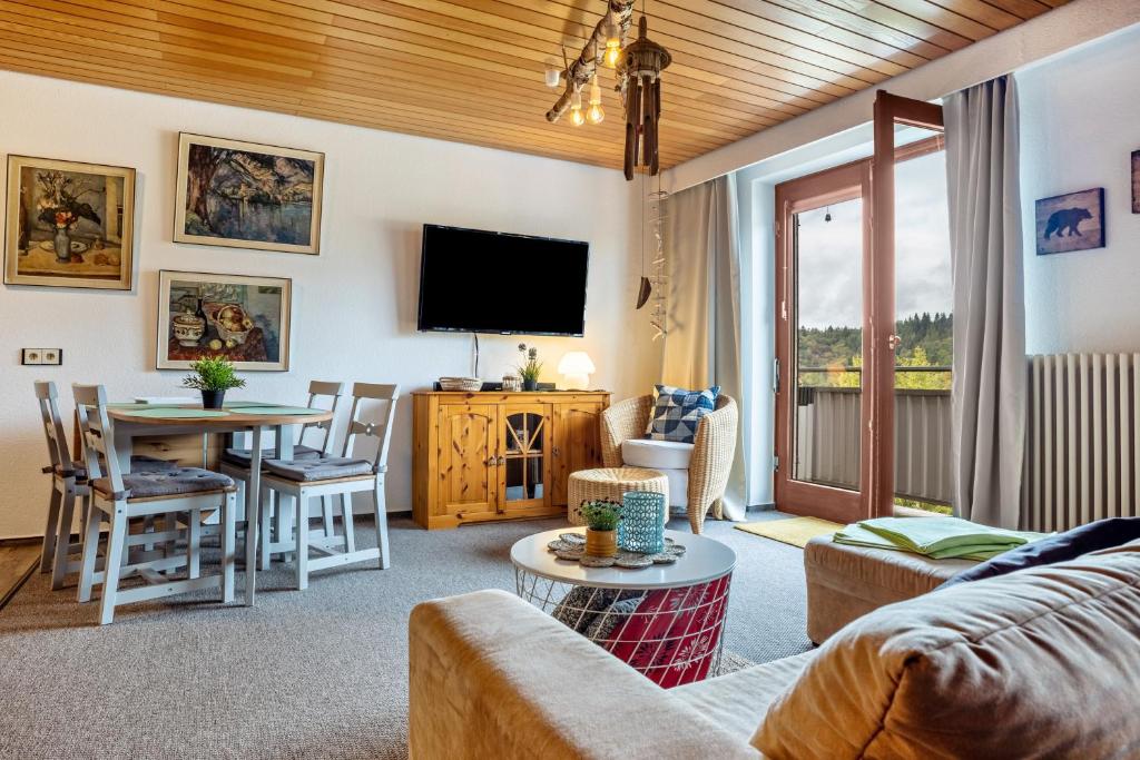 a living room with a couch and a table at Apartment Grundblick in Bad Grund