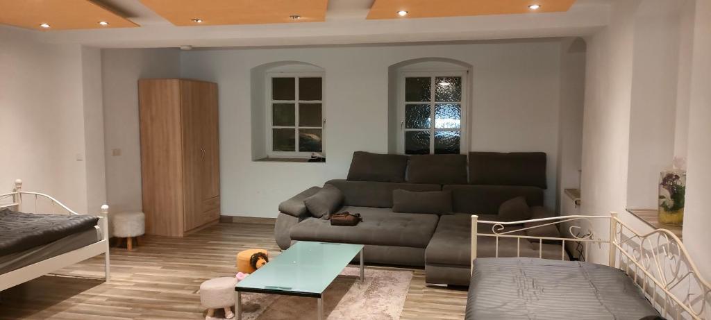 a living room with a couch and a table at Käfer A in Waldbrunn