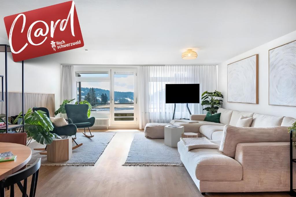 a living room with a couch and a tv at Fewo Am Feldberg Gipfel in Feldberg