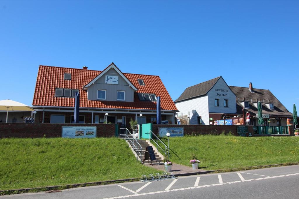 two houses on the side of a street with a road at Ferienwohnungen in Neufeld in Neufeld