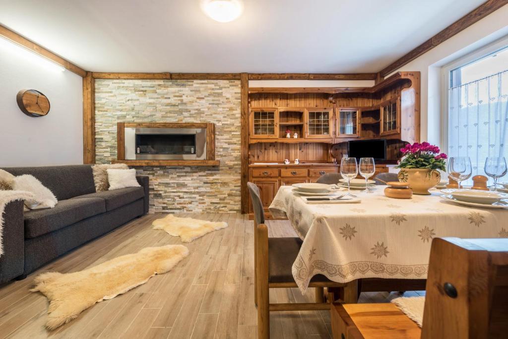 a living room with a table and a couch at Casa Ferrazza Michelle in Madonna di Campiglio
