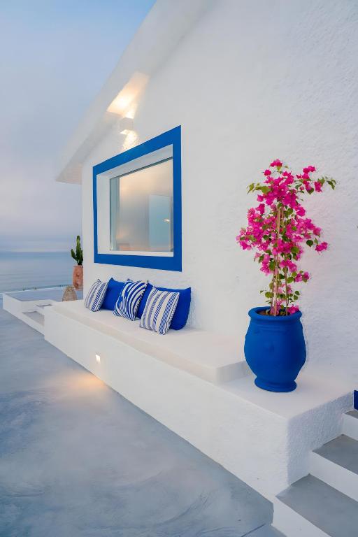 a blue pot sitting on a white wall with a plant at Casa da Praia Valmitão in Ribamar