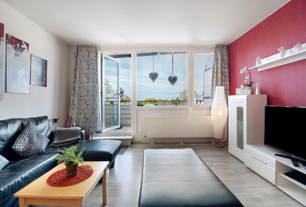 a living room with a couch and a tv at Ferienwohnung Manuela in Sankt Englmar