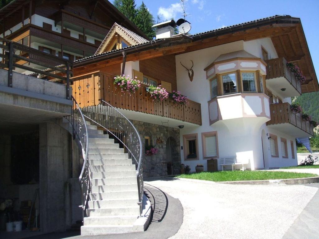a building with a staircase in front of it at Villa Mazzel - Cima 12 in Vigo di Fassa