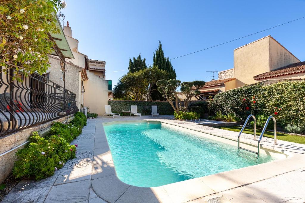 a swimming pool in front of a house at Villa Salamandre in Port-Saint-Louis-du-Rhône