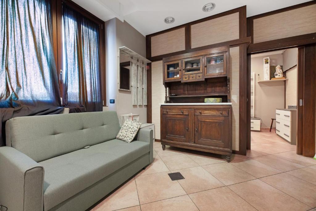 a living room with a couch and a kitchen at La Casa di Lu - Val D'Intelvi in Lanzo dʼIntelvi