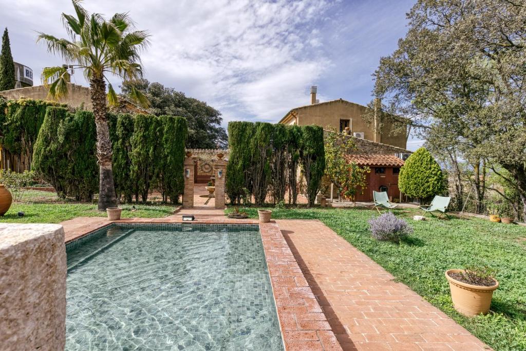 a swimming pool in the yard of a house at El Pedró Panoramic in Ventalló