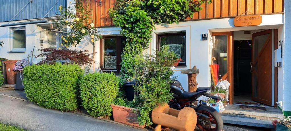 a motorcycle parked in front of a house at Schaumann’s Hüs in Immenstadt im Allgäu