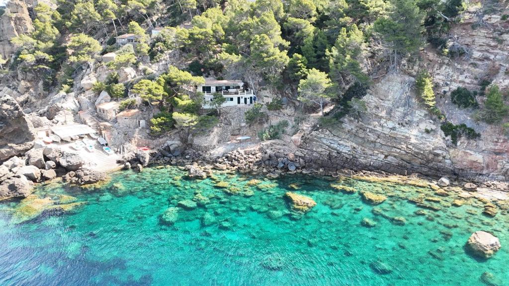 an aerial view of a house on a rocky mountain at Villa Banyalbufar in Banyalbufar