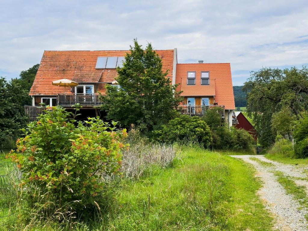 a house on the side of a dirt road at Hof Sinnenberg in Deggenhausertal