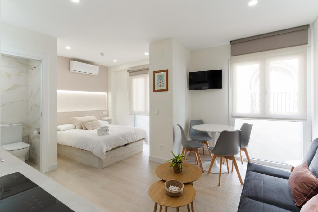 a bedroom with a bed and a table and chairs at Cala Sol - few steps from the beach in La Cala de Mijas