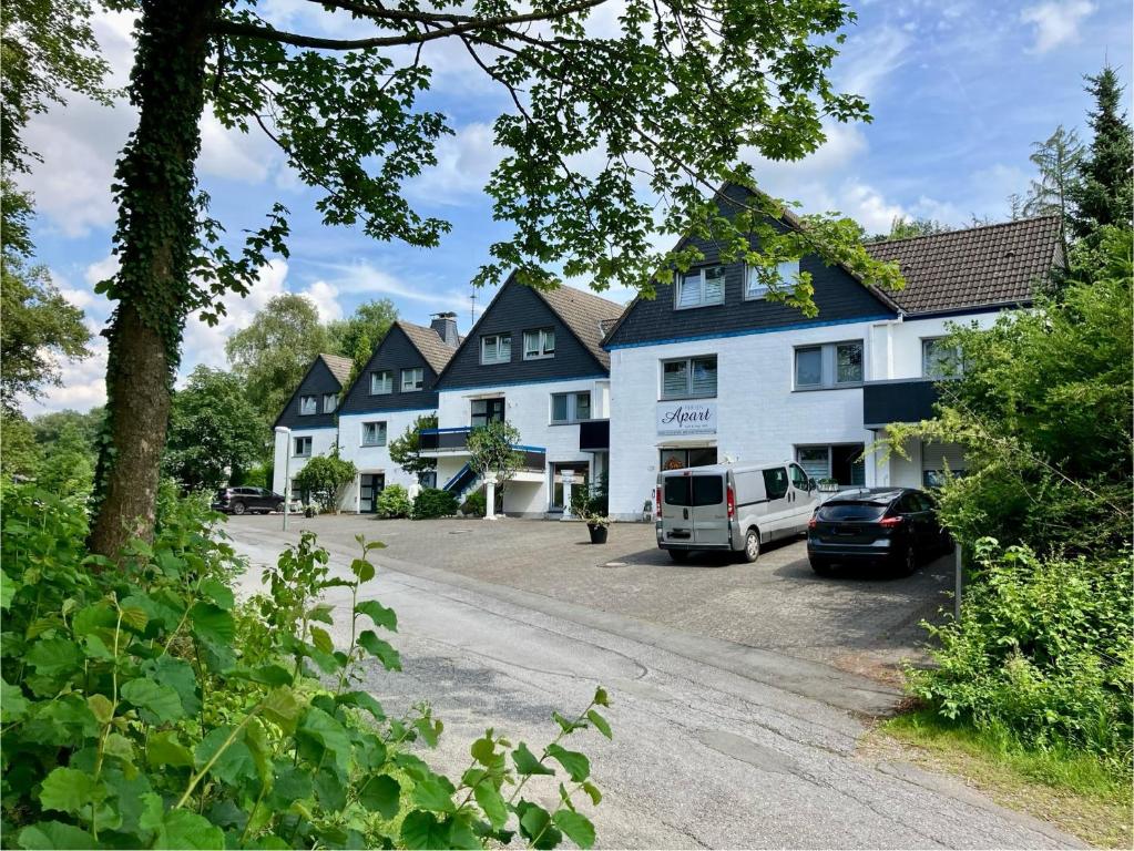 a large white building with a car parked in the driveway at Kehl Vogt Ferien Apart in Warstein