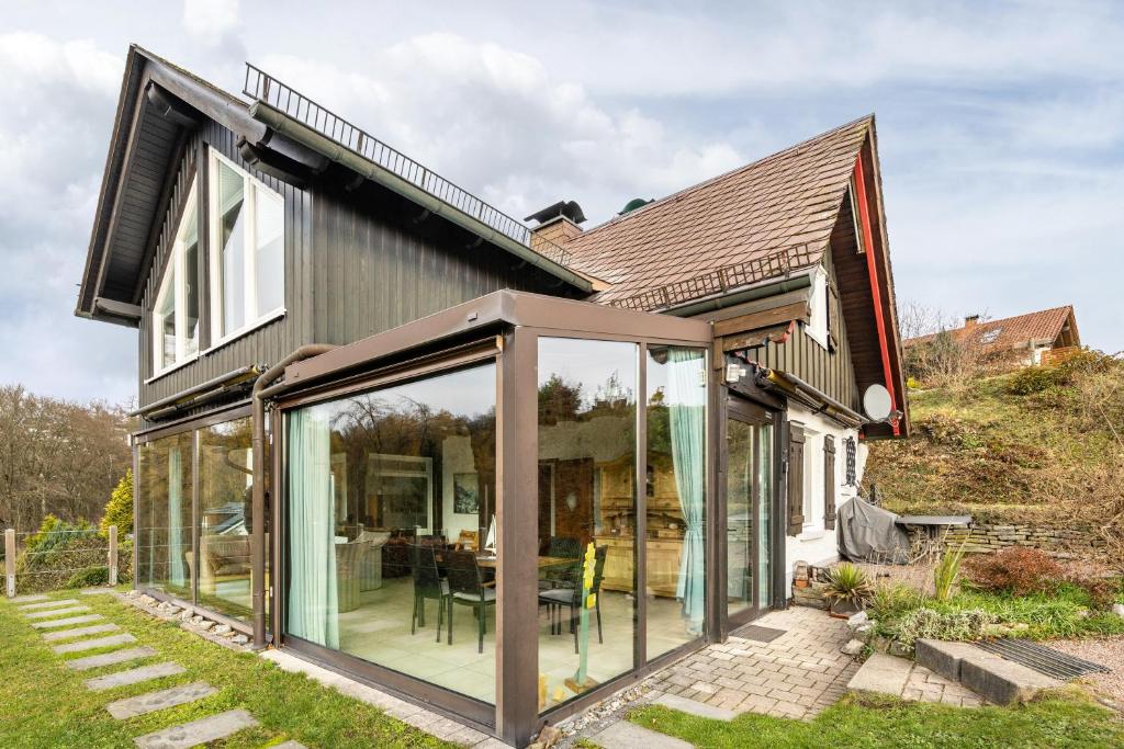 an extension to a house with sliding glass doors at Panoramaferienhaus Sorpesee, 120qm in Sundern