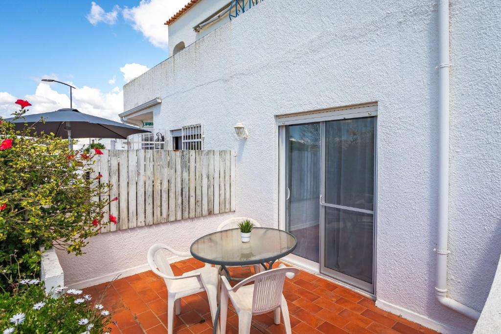 a patio with a table and chairs on a balcony at Isabel apartment in Carvoeiro