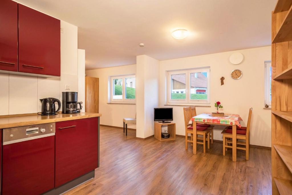 a kitchen and dining room with a table and a kitchen and a room at Ferienhof Weber Wohnung Fichte in Neukirch