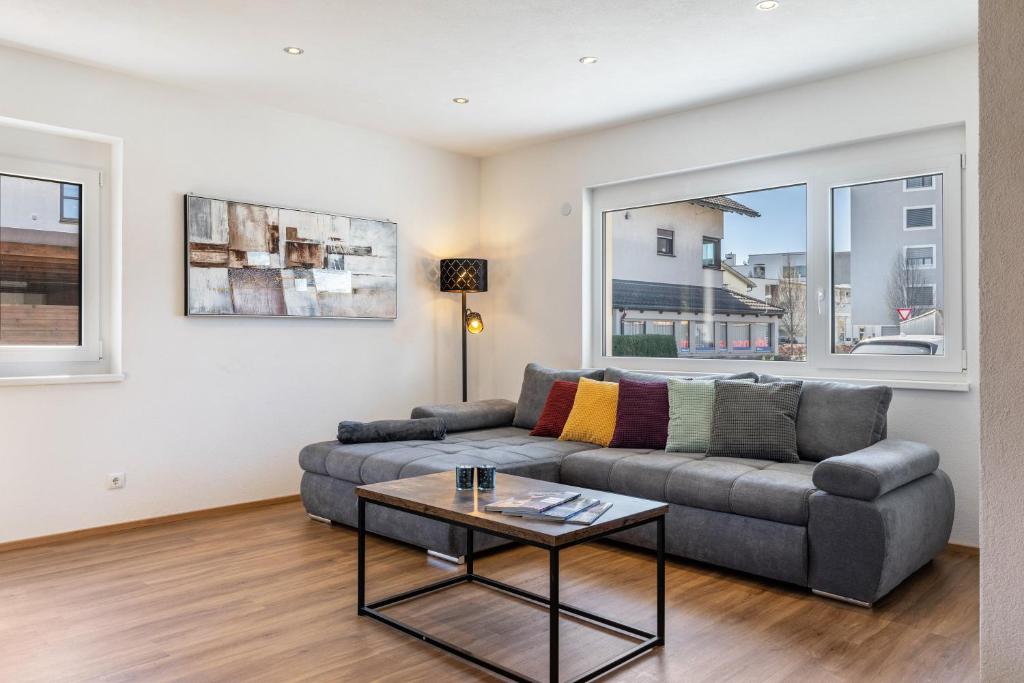 a living room with a couch and a table at Apartments Winder 1 in Lustenau