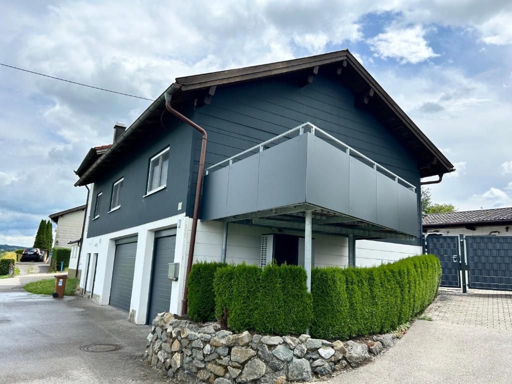 a blue and white house with bushes in front of it at Ferienhaus Frank Grieser in Hopferau