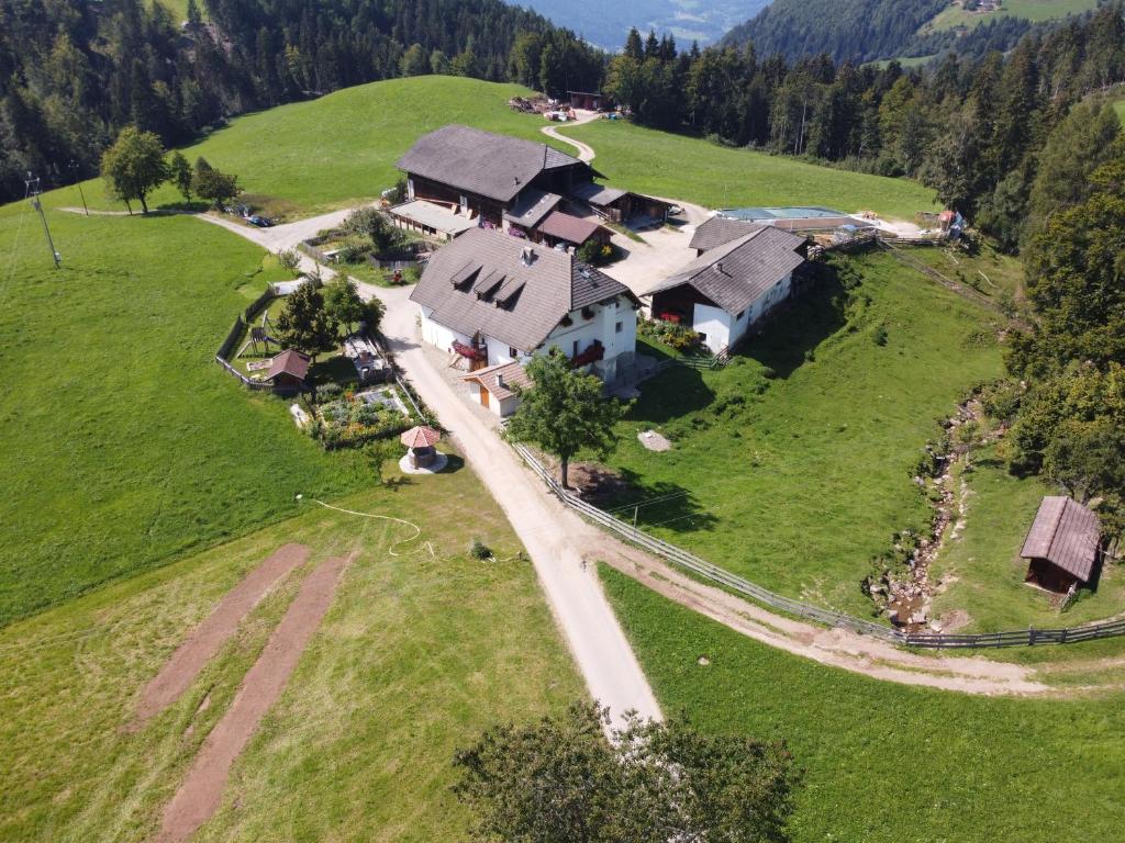 an aerial view of a house on a green field at Ronacherhof Apt Ringelblume in Collalbo