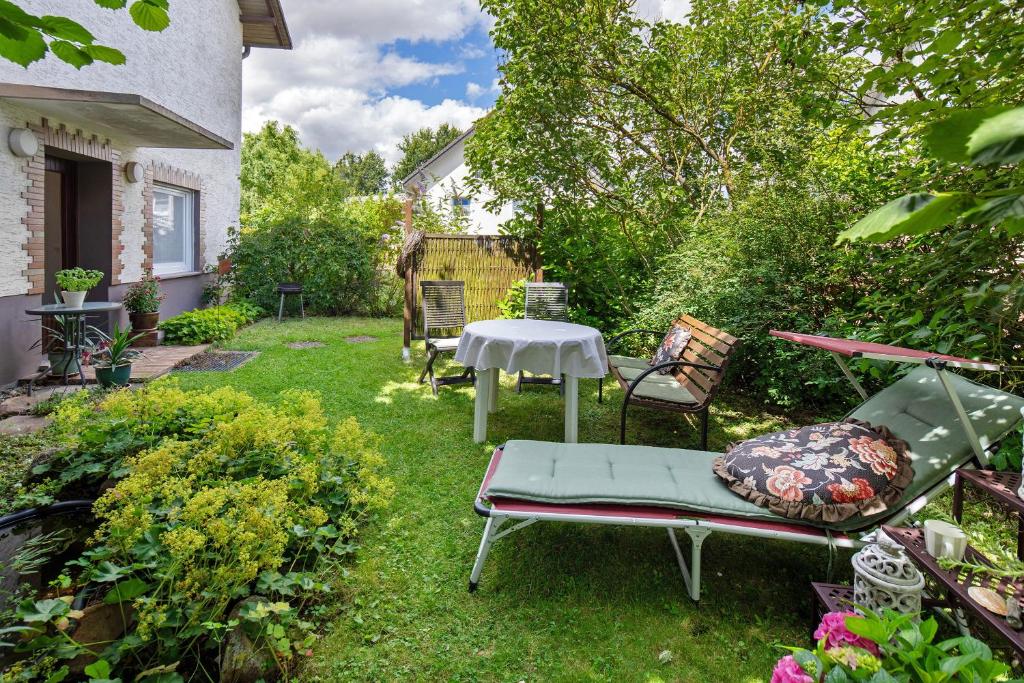 ein Garten mit einem Tisch und Stühlen im Rasen in der Unterkunft Ferienwohnung Schwalm - Aue in Neuental