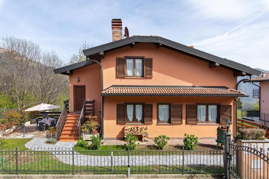a house with a fence in front of it at Intelvi House in Castiglione dʼIntelvi