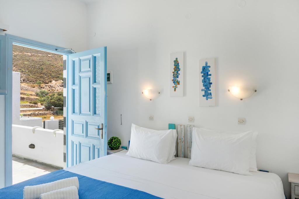 a bedroom with a bed and an open door at Pico Bello Patmos 24 in Patmos