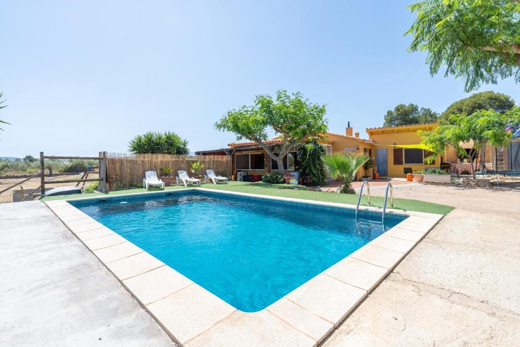a swimming pool in the backyard of a house at Can Boquera in L'Ametlla de Mar
