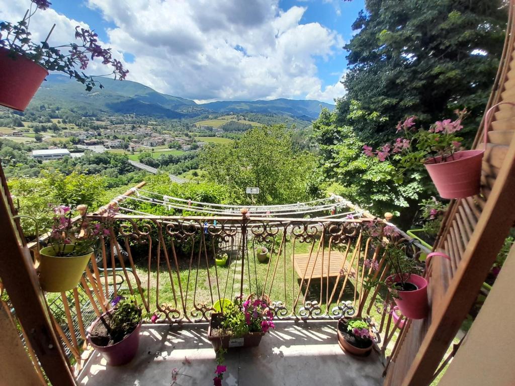 a balcony with a view of a garden at La Vista Sul Castello in Compiano