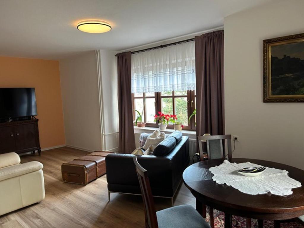 a living room with a couch and a table at Ferienhaus Waldeck in Marienberg