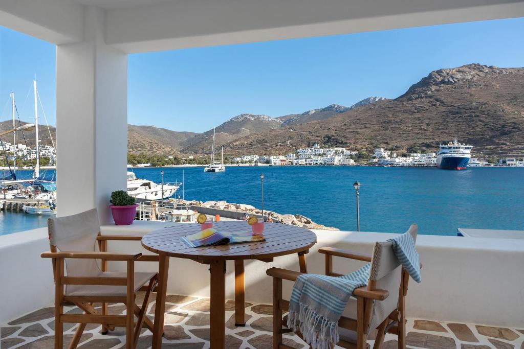 a table and chairs on a balcony with a view of a harbor at Nicolas House 2 in Rakhídhion