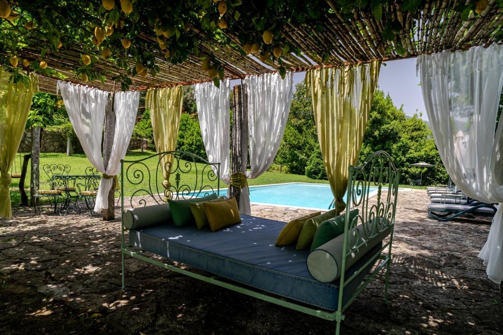 a bed in a gazebo next to a pool at Quinta de Amares in Amares