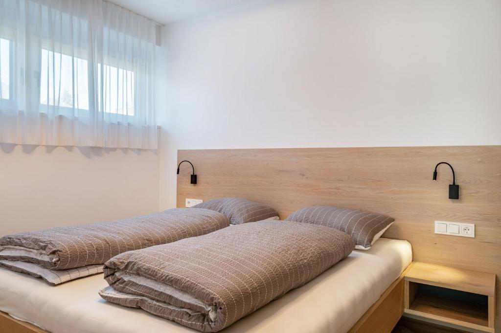 two beds with pillows on them in a room at Mountain Meadows Apt 2 in Valdaora