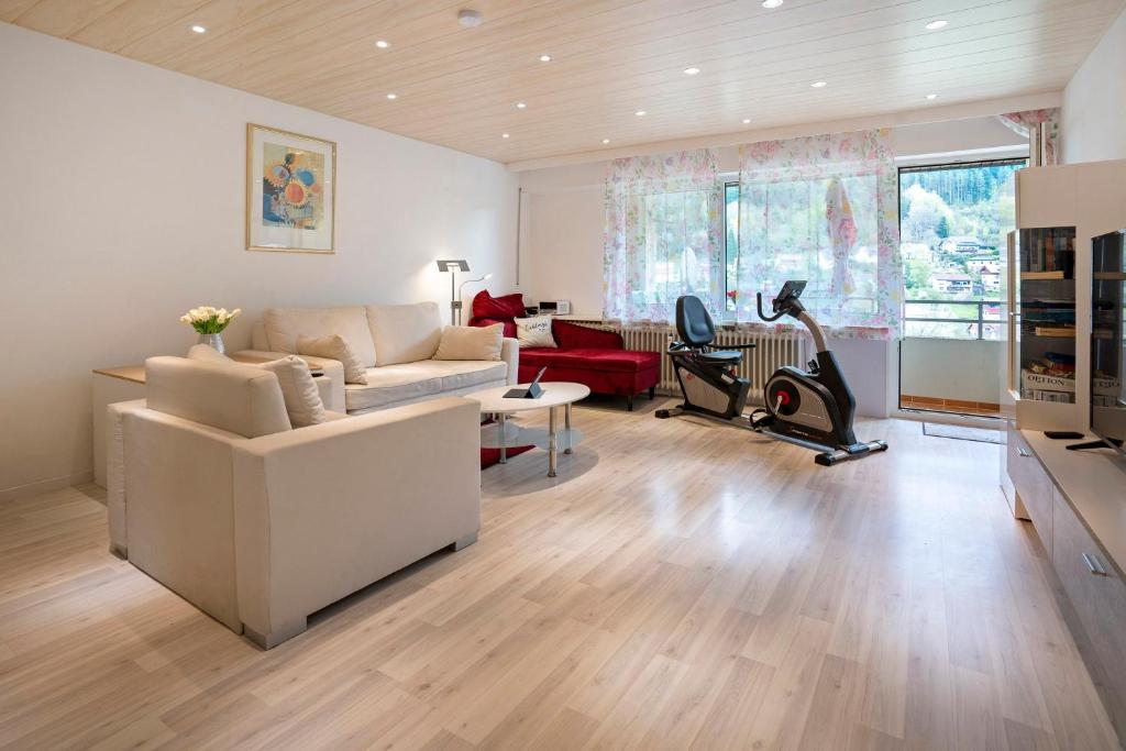 a living room with a couch and a gym at Fewo Talblick mit Schwimmbad in Bad Wildbad