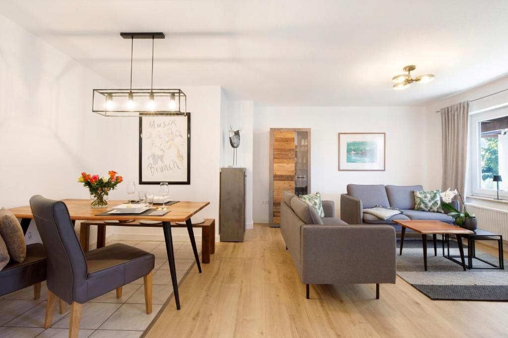 a living room and dining room with a table and chairs at Waldmariechen in Neresheim