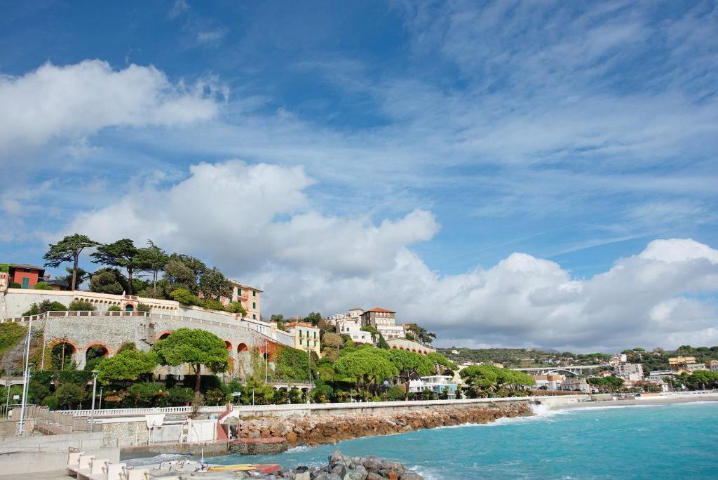 a view of a beach with houses on a hill at Dai Baccino in Celle Ligure