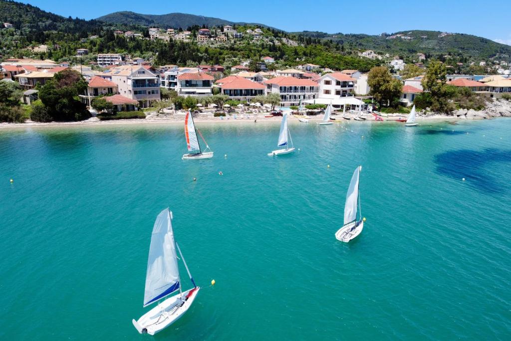 a group of sailboats in the water near a beach at M2 room in Nikiana