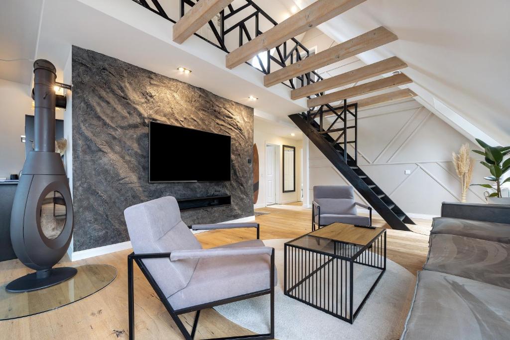 a living room with a fireplace and a tv at Penthouse Kokorey in Halstenbek