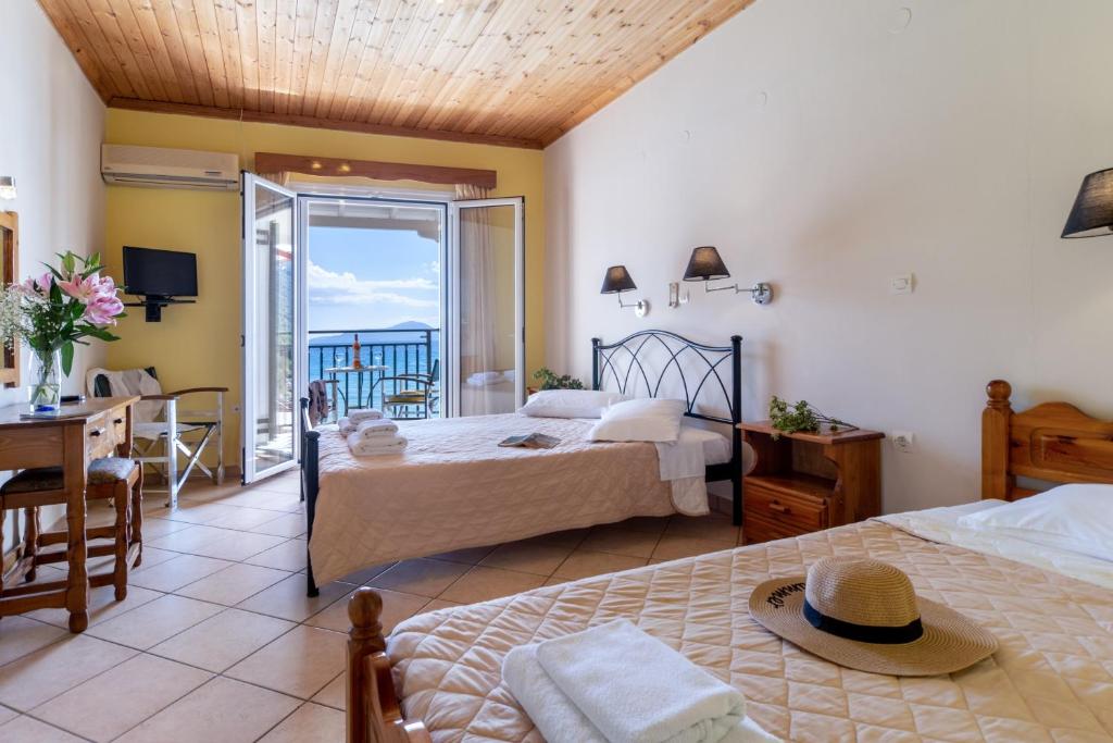 a hotel room with two beds and a balcony at Apostolos Apartment 4 in Póndi