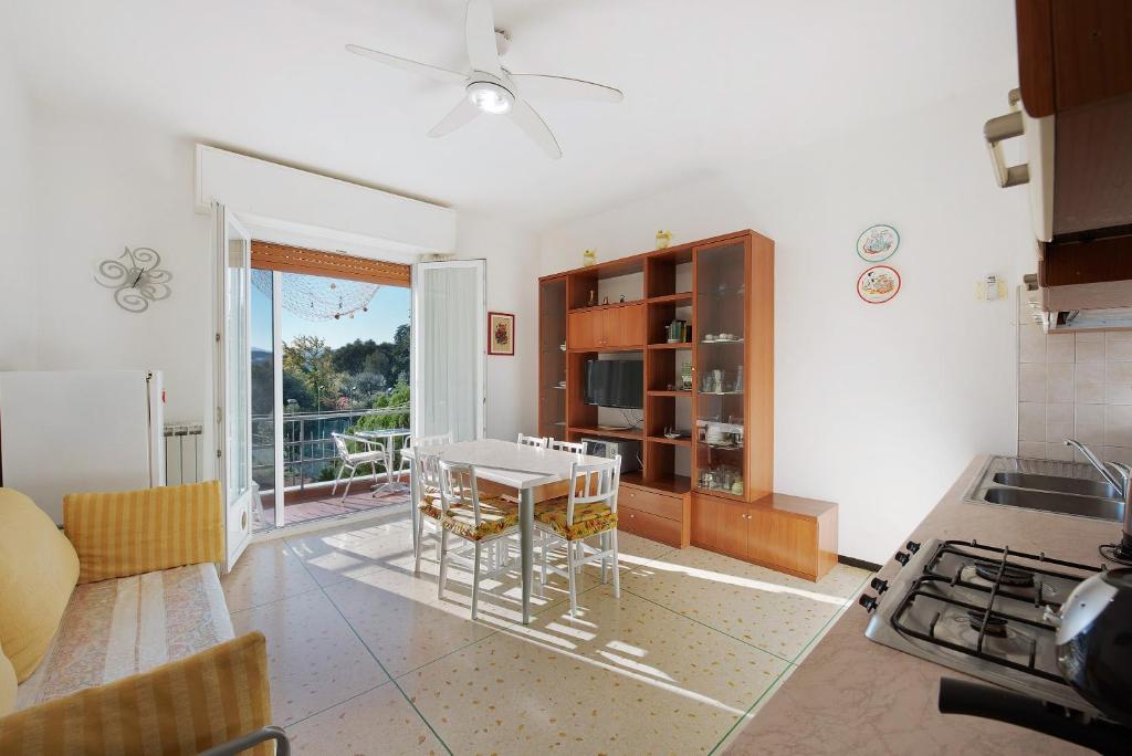 a kitchen with a table and a dining room at Il Corallo in Albisola Superiore
