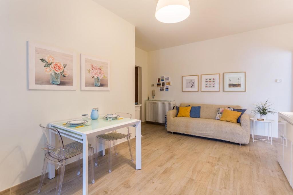 a living room with a table and a couch at La Terrazza in Brunate