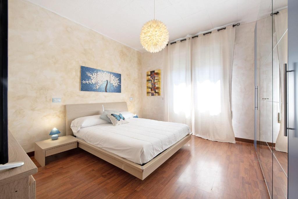 a bedroom with a bed and a chandelier at Il ponte dei sogni in Brescia