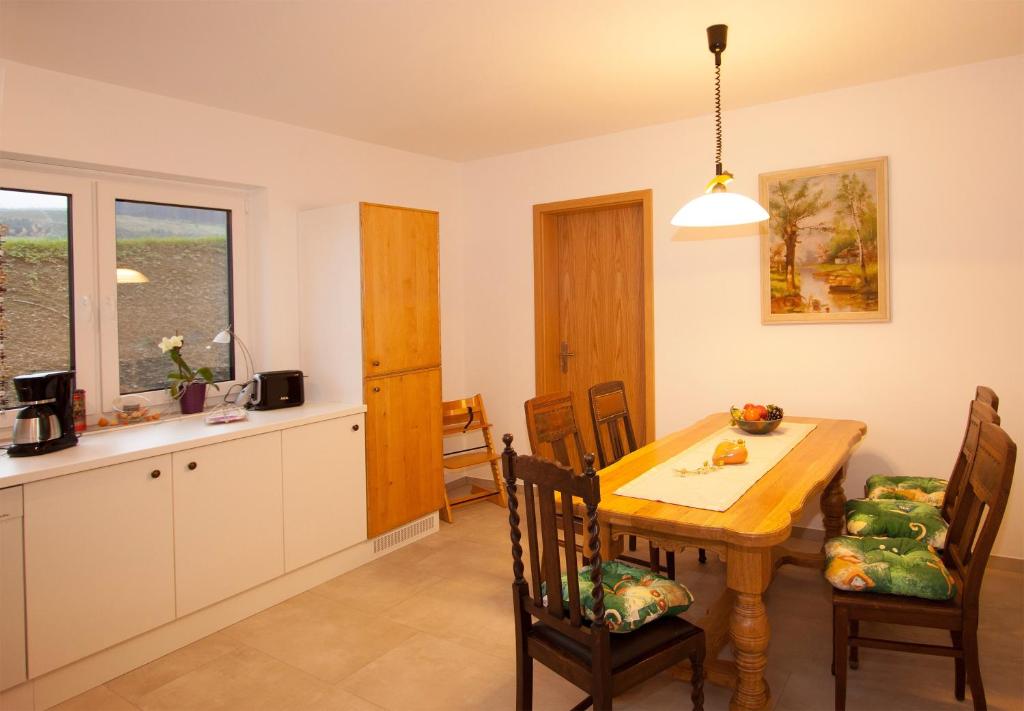 a kitchen and dining room with a table and chairs at Ferienwohnung Mertens in Schmallenberg