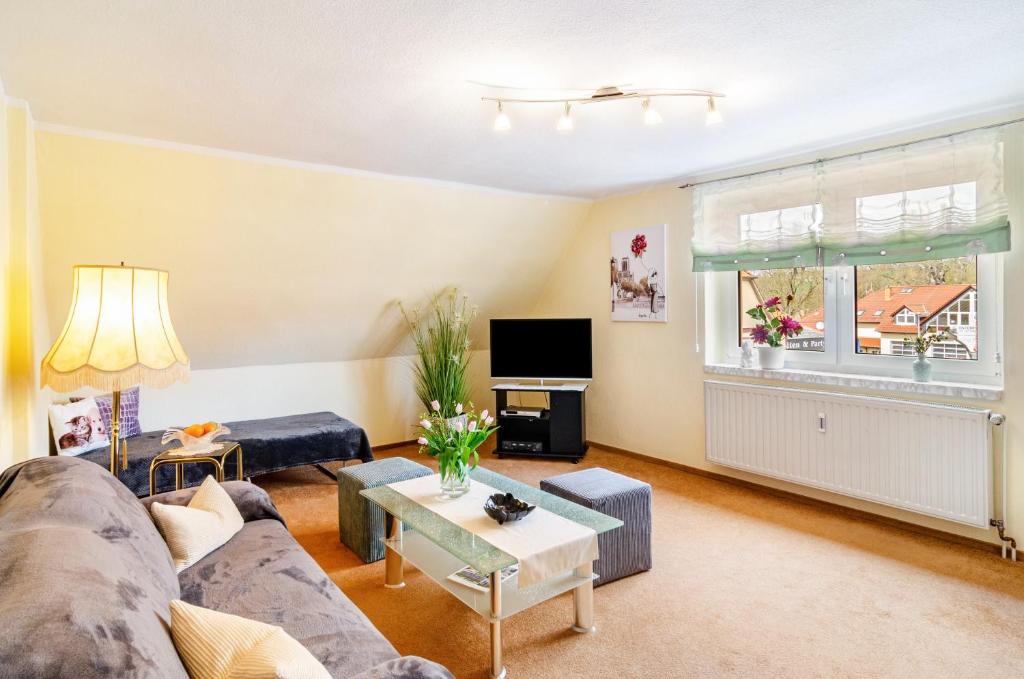 a living room with a couch and a table at Ferienwohnung Inge in Uder