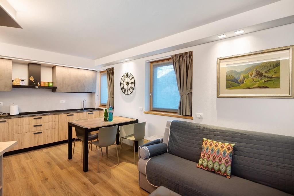 a living room with a couch and a table at Chalet Emma Isolaccia in Valdidentro
