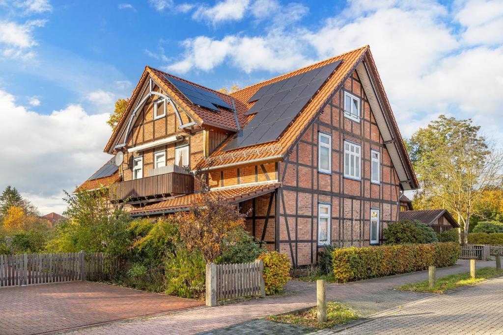 a house with solar panels on the roof at Ferienwohnung Örtzetal in Hermannsburg
