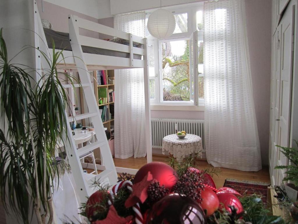 a room with a loft bed and a pile of fruit at Apartment Am Birnbaum in Reutlingen