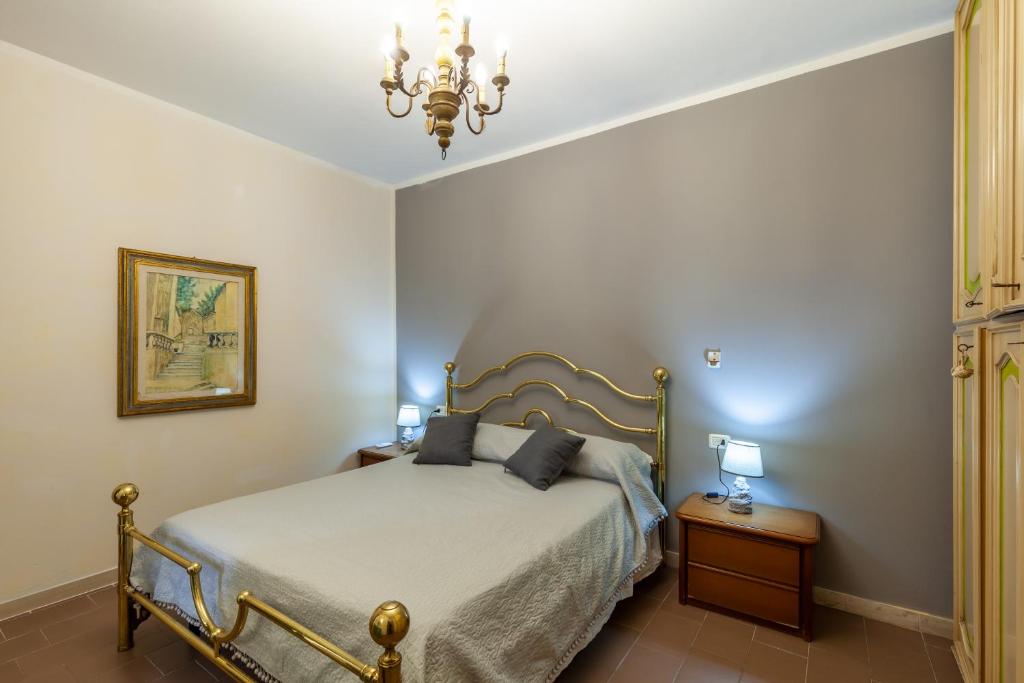 a bedroom with a bed and a chandelier at Residence Caravel 9 in Lido di Camaiore