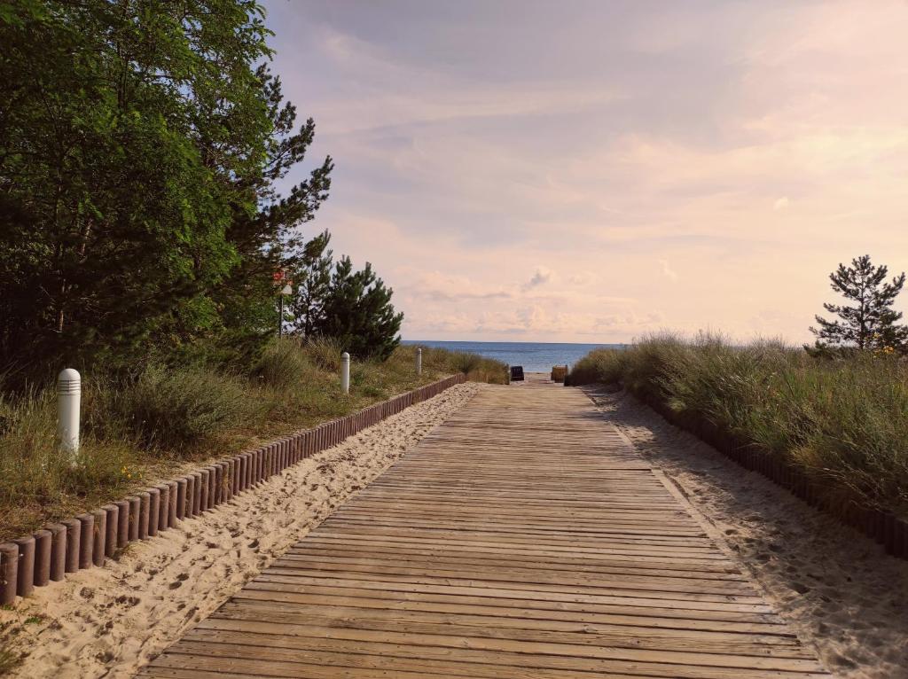 a wooden path leading to the beach at Ostseeperle Karlina in Karlshagen